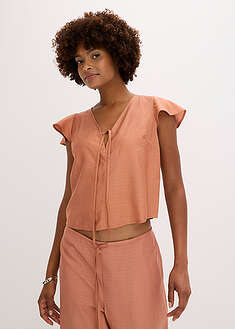 Kiiltävä pusero liehuhihoilla