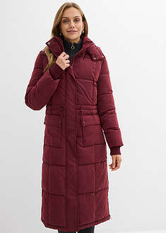 Pitkä tikattu talvitakki, jossa sivuilla vetoketjut